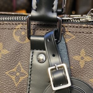 Luggage tag strap and buckle at the handle