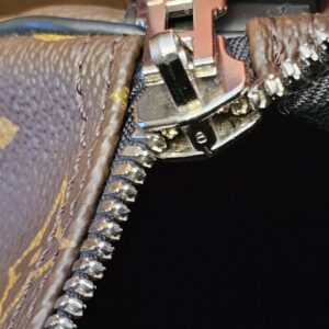 Silver-tone zip pull on the double zip