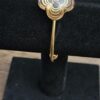 Louis Vuitton A La Folie Resin Bracelet Gold - front view of the clear resin flower on a display stand