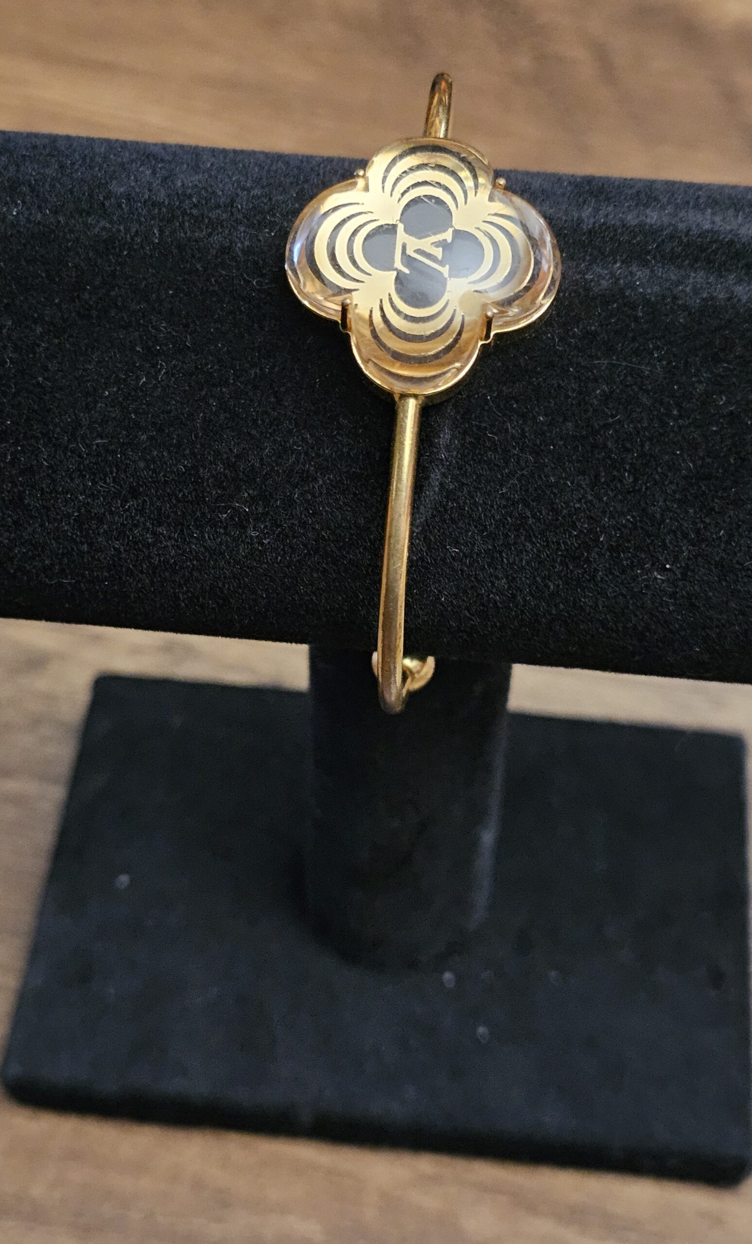 Louis Vuitton A La Folie Resin Bracelet Gold - front view of the clear resin flower on a display stand