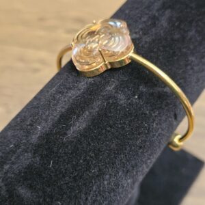 Resin flower from the side showing the gold-tone setting