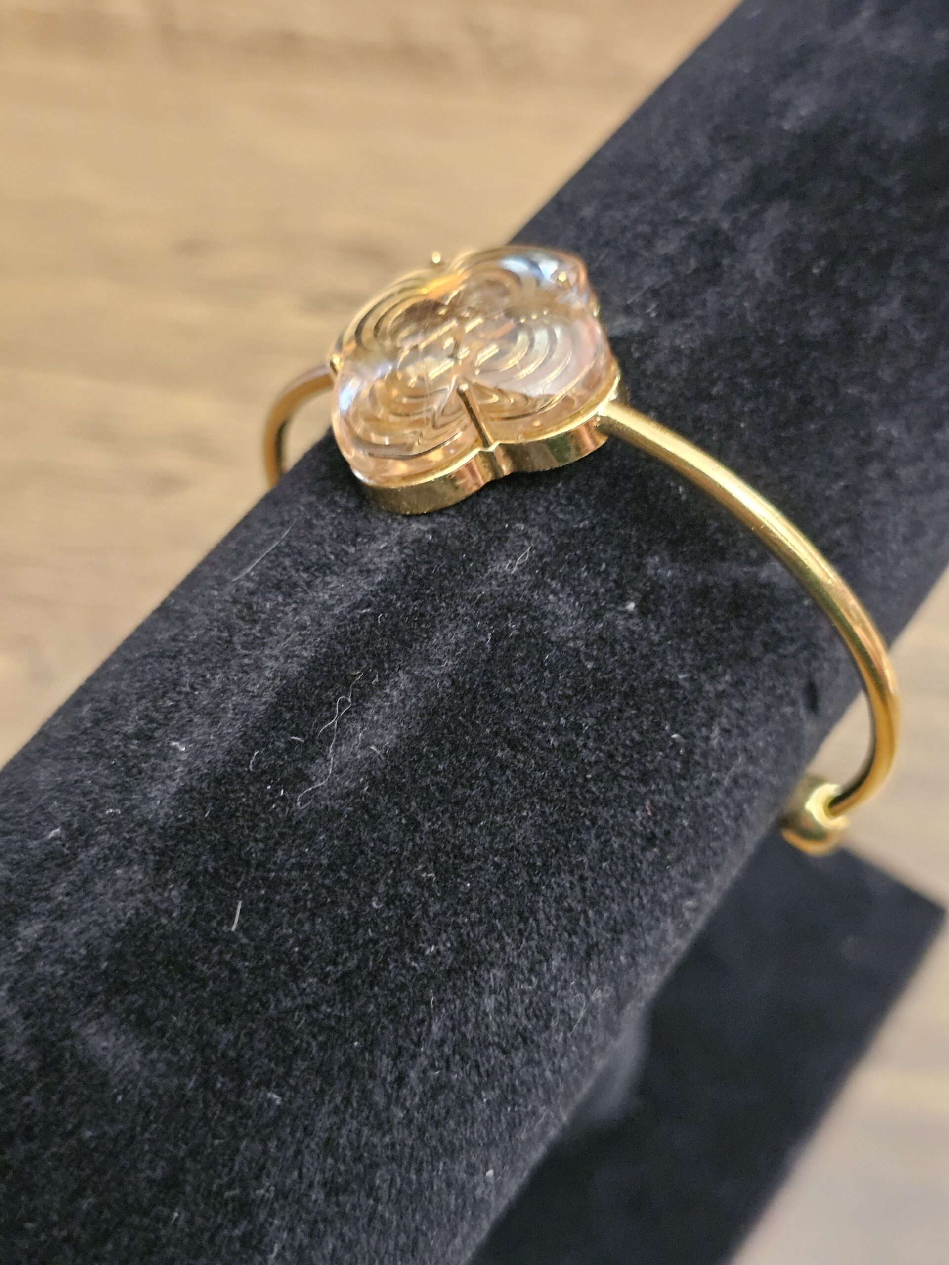 Resin flower from the side showing the gold-tone setting