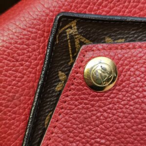 Close up of the gold-tone LV snap and Monogram canvas layer