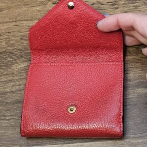 Outer flap opened showing the inner red leather flap and snap
