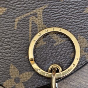 Engraved gold-tone key ring on the Monogram reverse