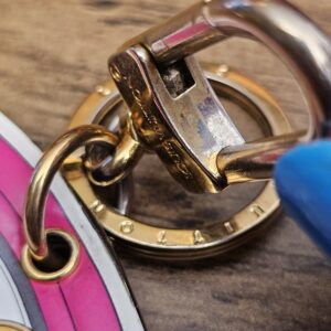 Swivel clasp hinge showing scratches and discoloration