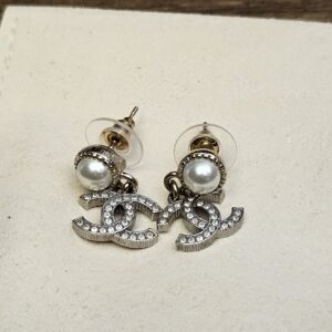 Pair laid flat showing the pearl studs and CC drops