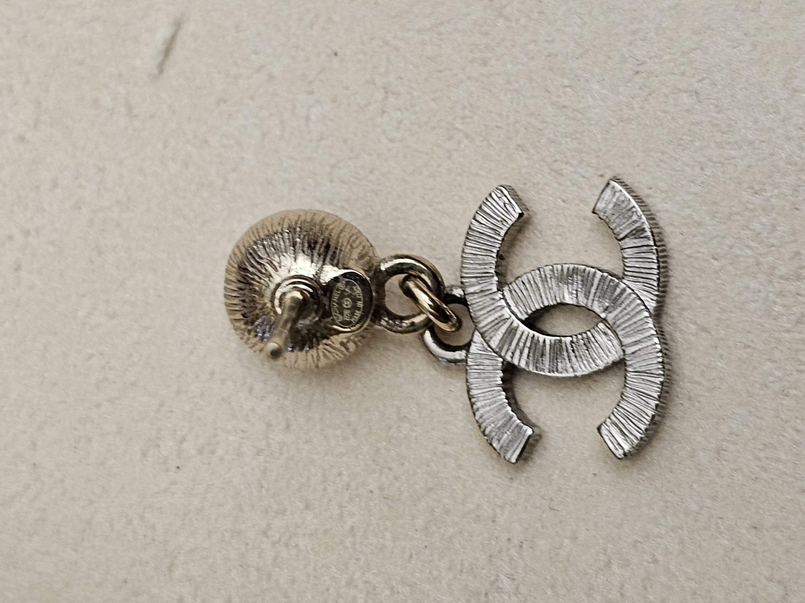 Back of the earring showing the textured CC drop