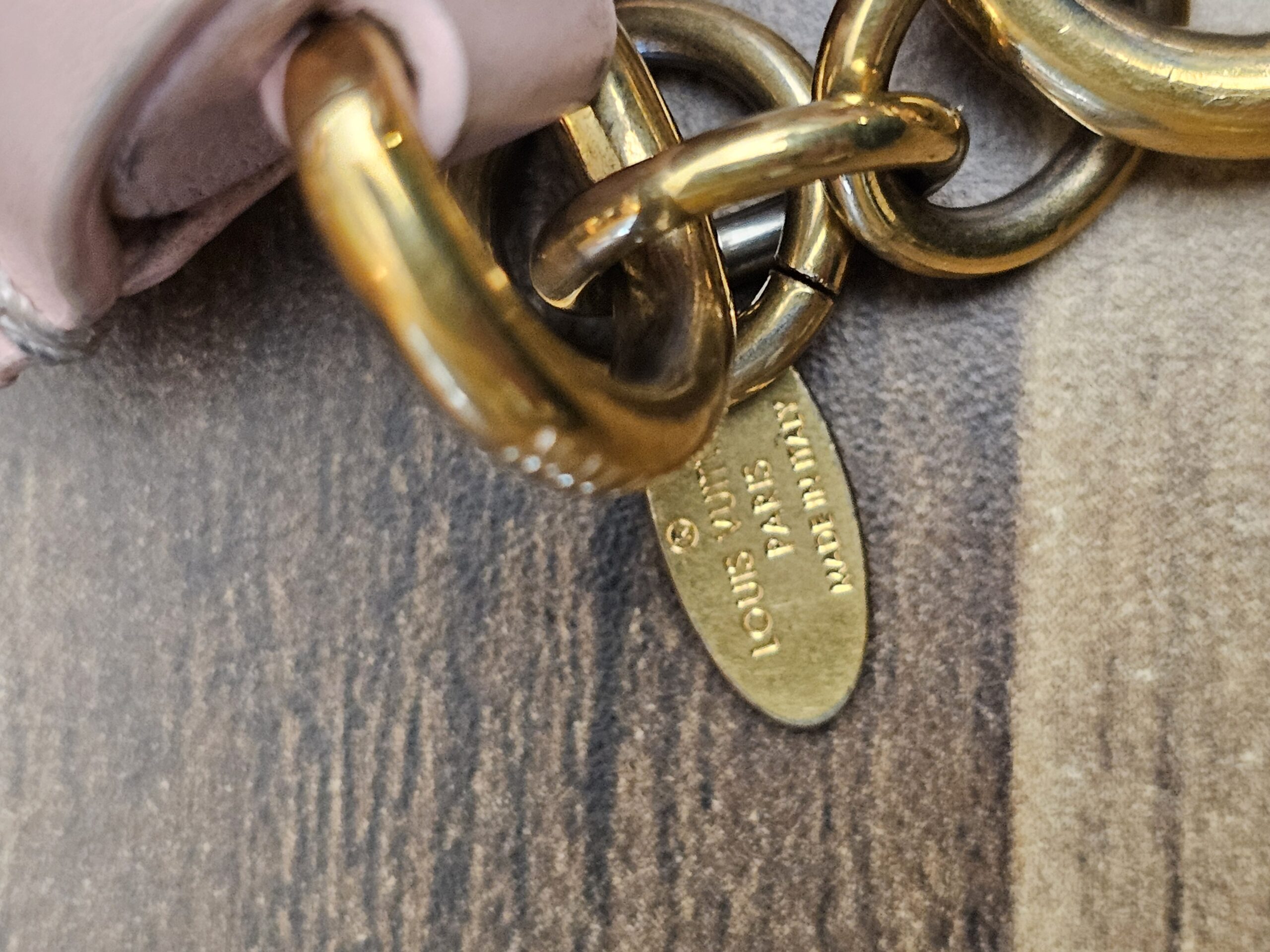 Chain and tag showing scratches and finish wear