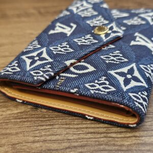 Closed wallet at an angle showing the tan leather edge