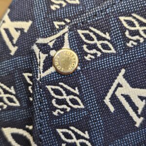 Close up of the gold-tone snap on the jacquard flap