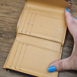 Wallet opened flat showing the card slots and zip coin pocket