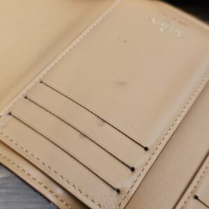 Close up of the card slots with light marks on the leather