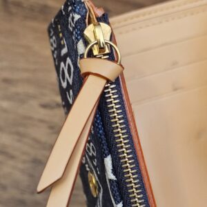 Leather zip pull on the coin compartment