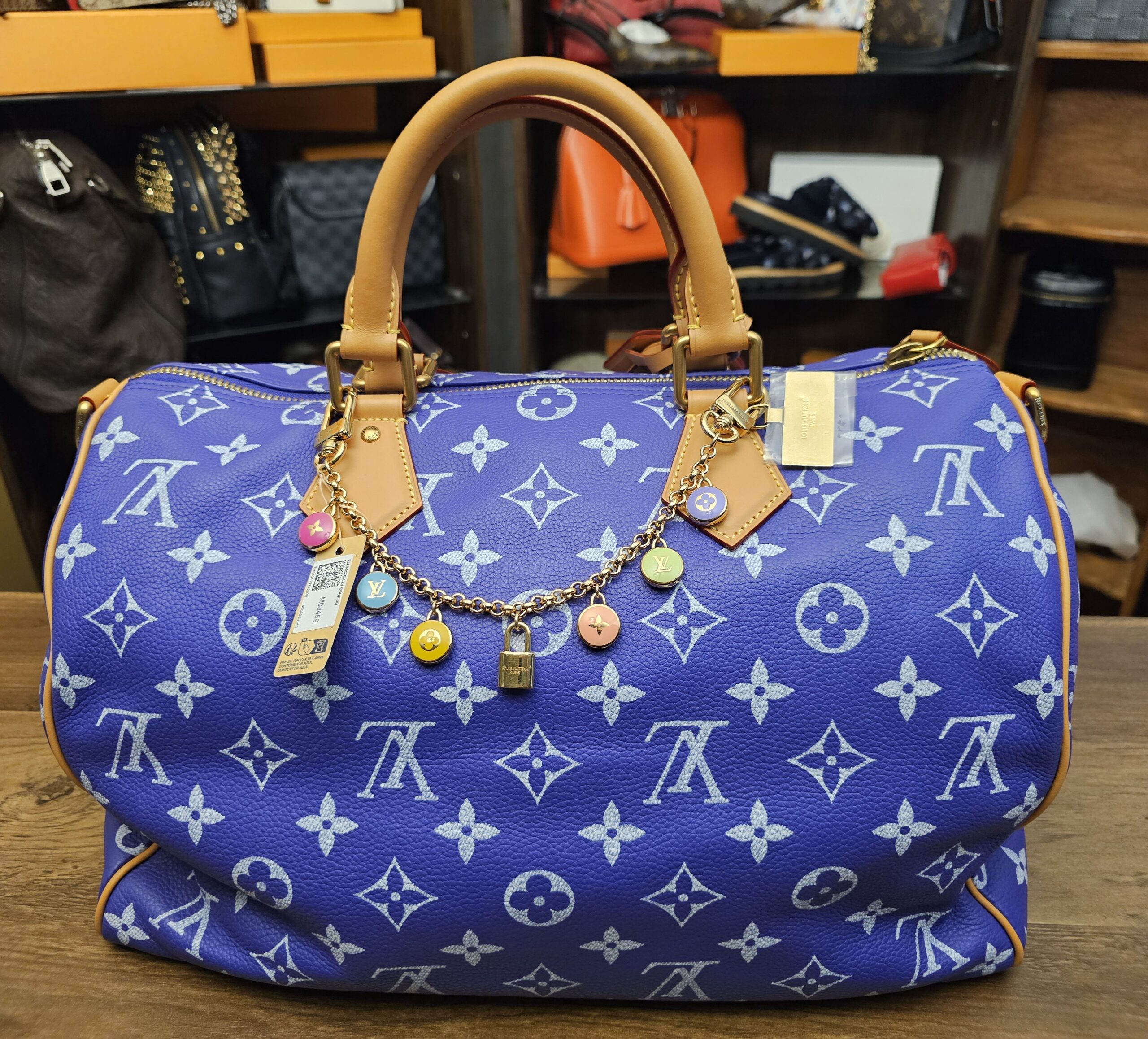 The chain charm on a blue Monogram canvas bag