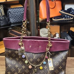 The chain charm on a Monogram canvas tote