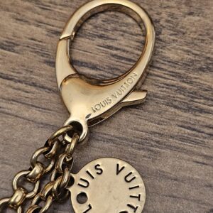 Engraved lobster clasp above the cutout disc