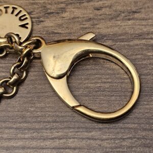 Back of the disc beside the lobster clasp