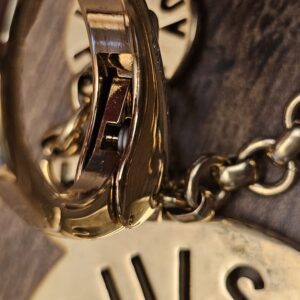 Close up of the clasp hinge showing wear on the gold-tone finish