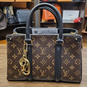 The charm on a Monogram canvas bag for scale