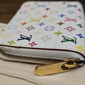 Gold-tone zip pull along the top