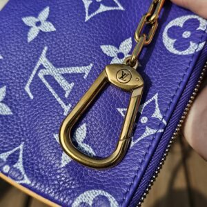 Gold-tone clasp on the pouch chain