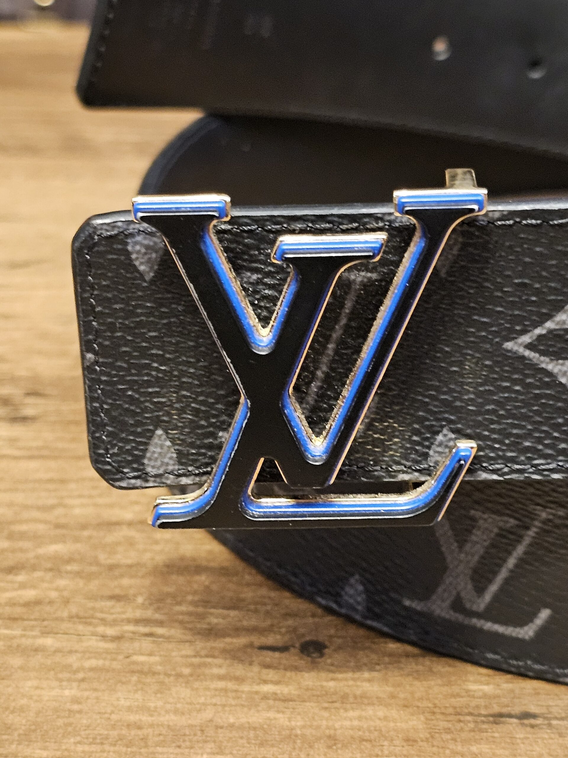 Black LV buckle with blue edges, close up