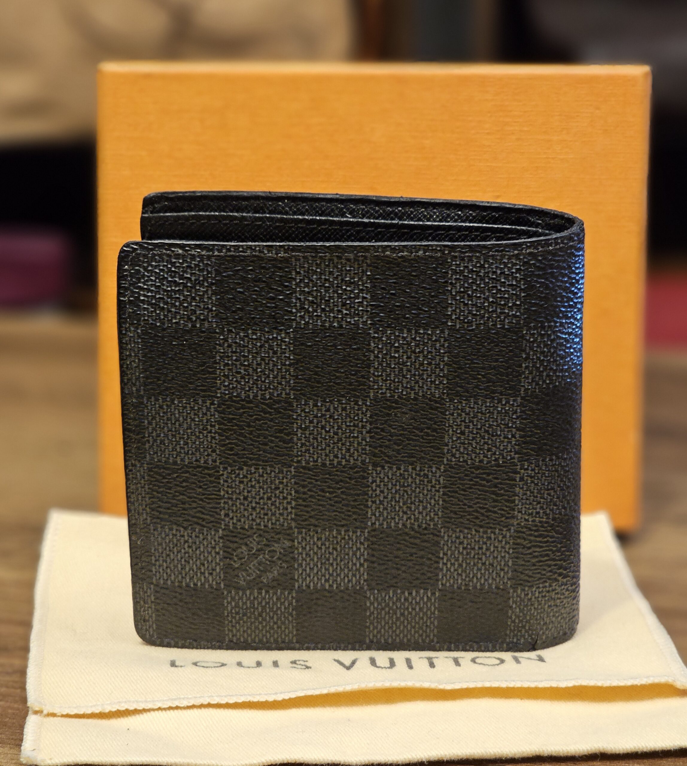 Back of the wallet with the box and dust bag