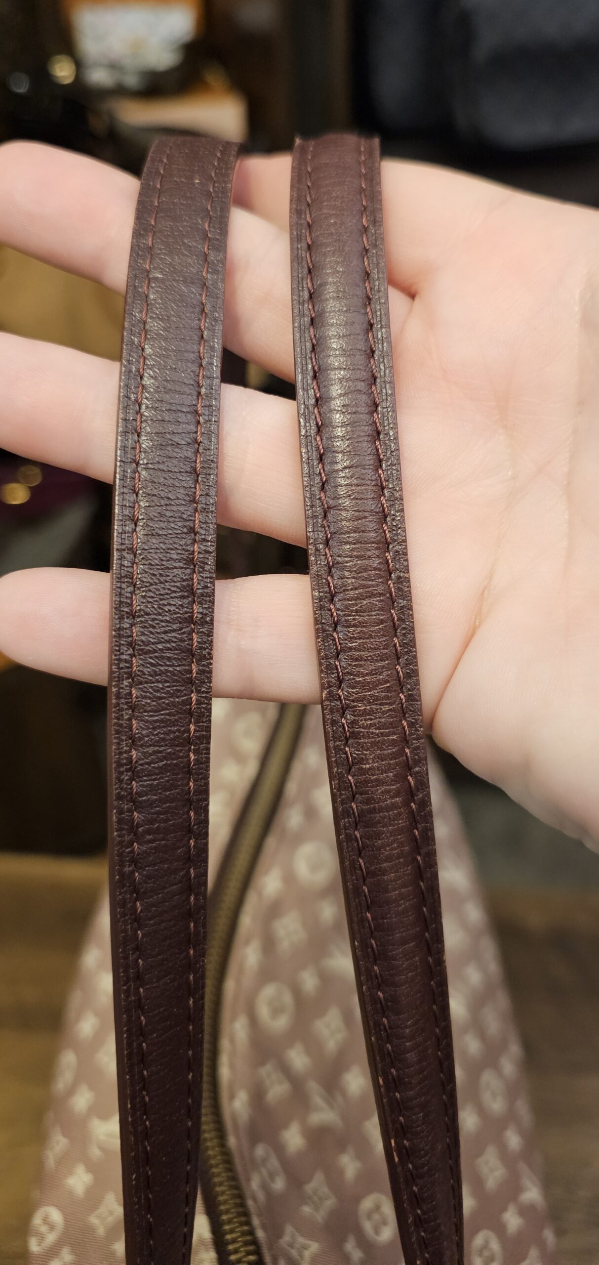 Dark brown leather shoulder straps held up
