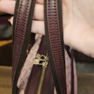 Flat canvas and leather shoulder straps held up