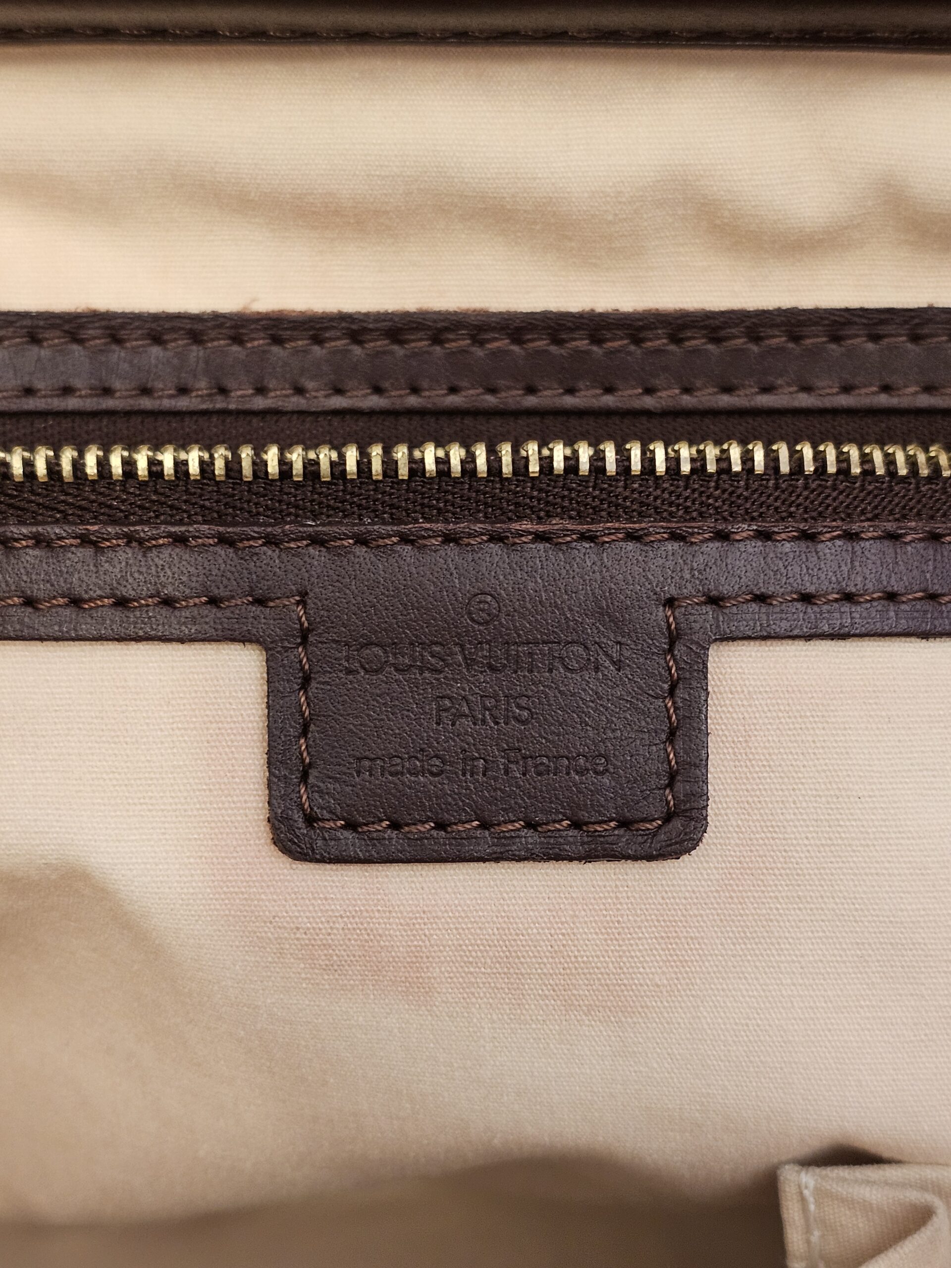 Made in France heat stamp patch above the zip pocket