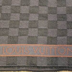 Woven signature along the rust stripe