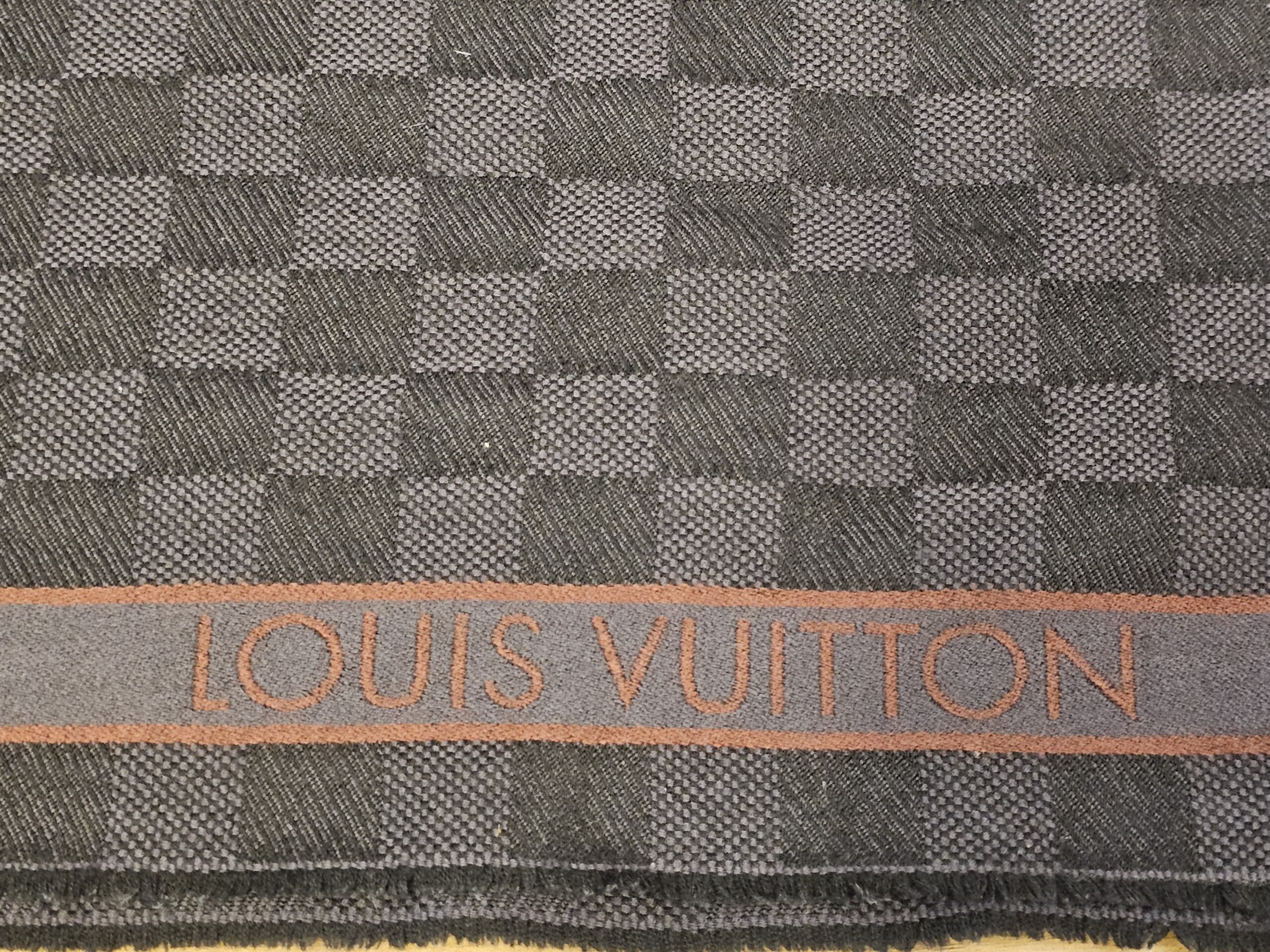 Woven signature along the rust stripe
