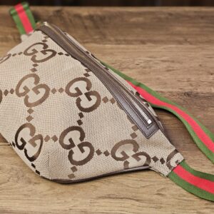Gucci Jumbo GG Canvas Web Belt Bag, three-quarter view with the Web strap