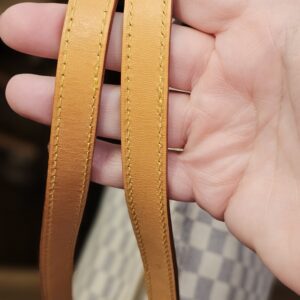 Shoulder straps held in hand