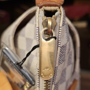 Side zip end and gold-tone zip pull