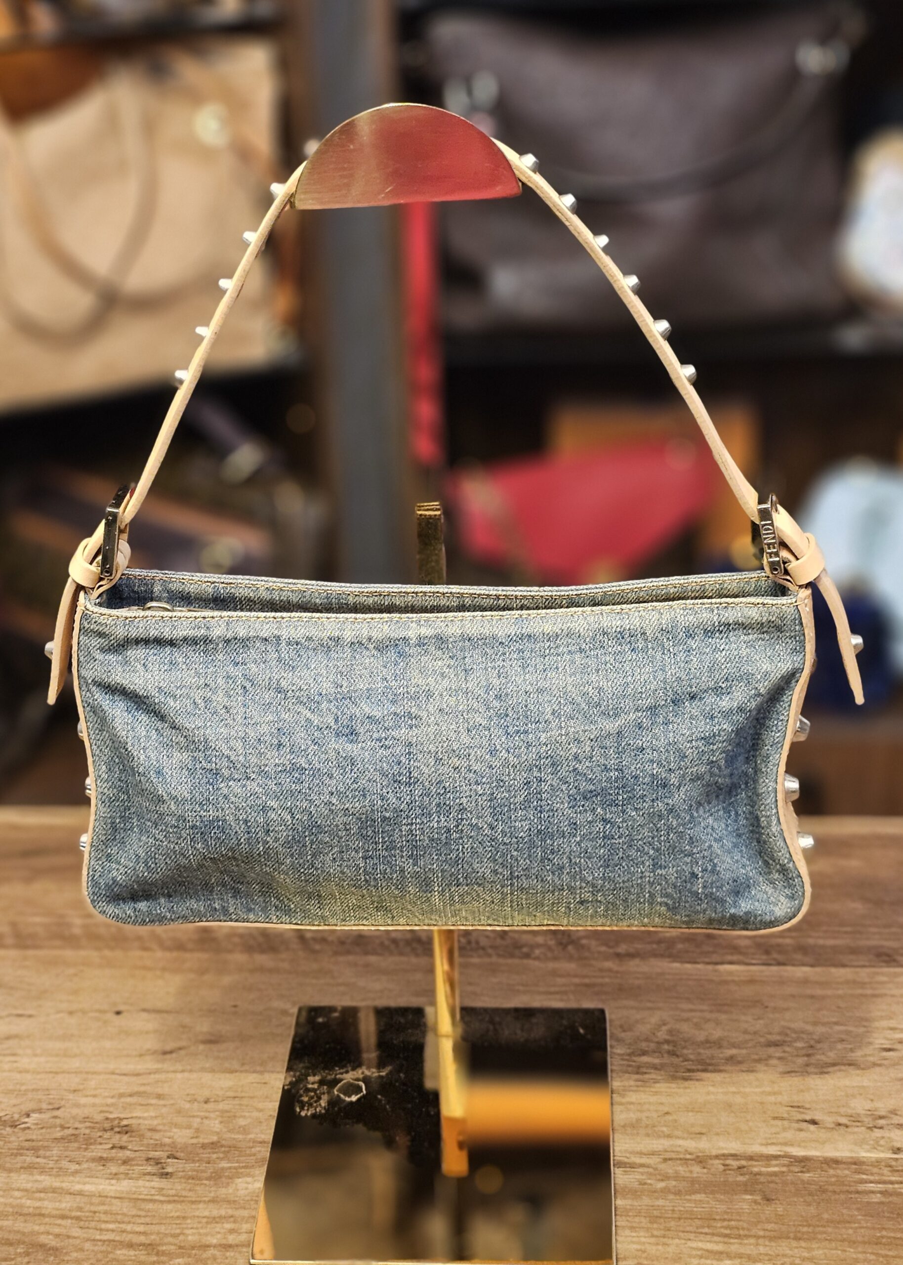 Fendi Denim Studded Shoulder Bag, front view on a stand with the studded strap