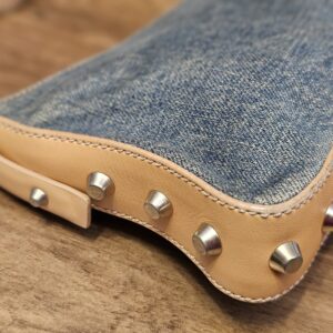 Close up of a corner with studs and light wear to the trim edge