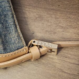 Engraved logo zip pull on the leather tab