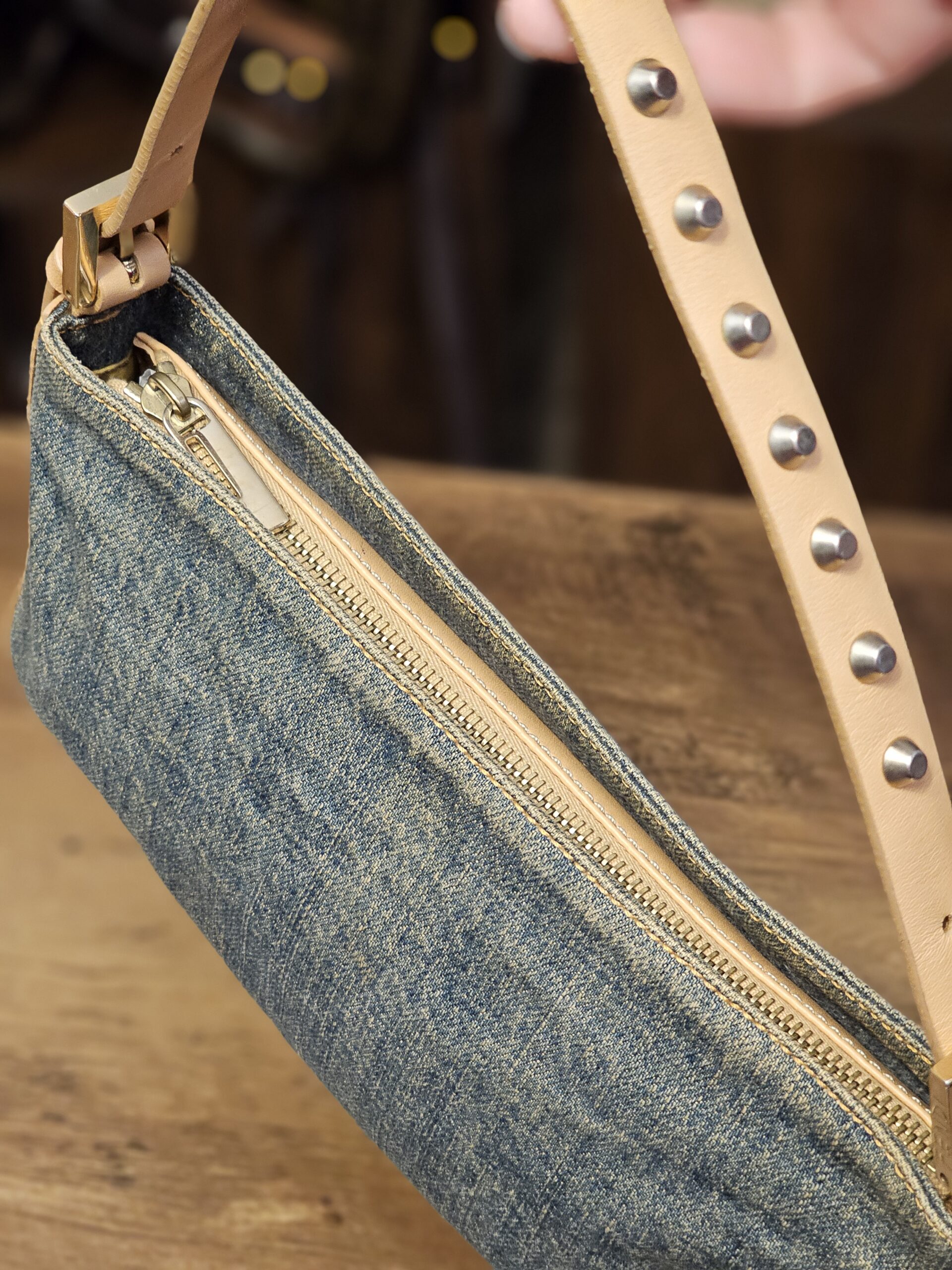 Side view with the zip top and studded strap