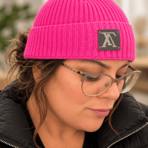 Beanie worn with the cuff folded and the logo patch at the front